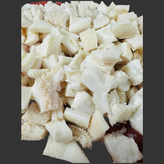 Diced white cheese on a red surface