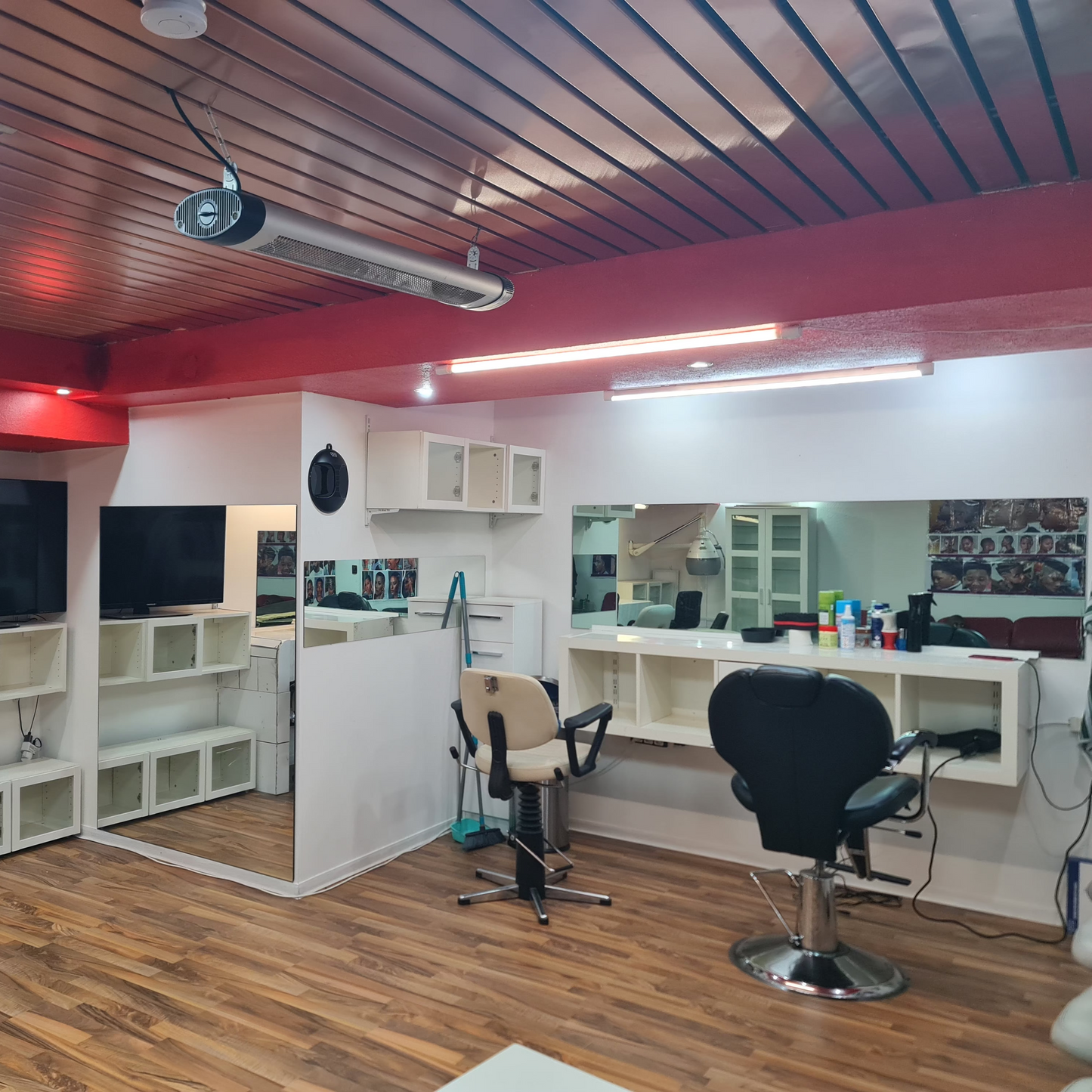 Modern office space with desks, chairs, and large screens.