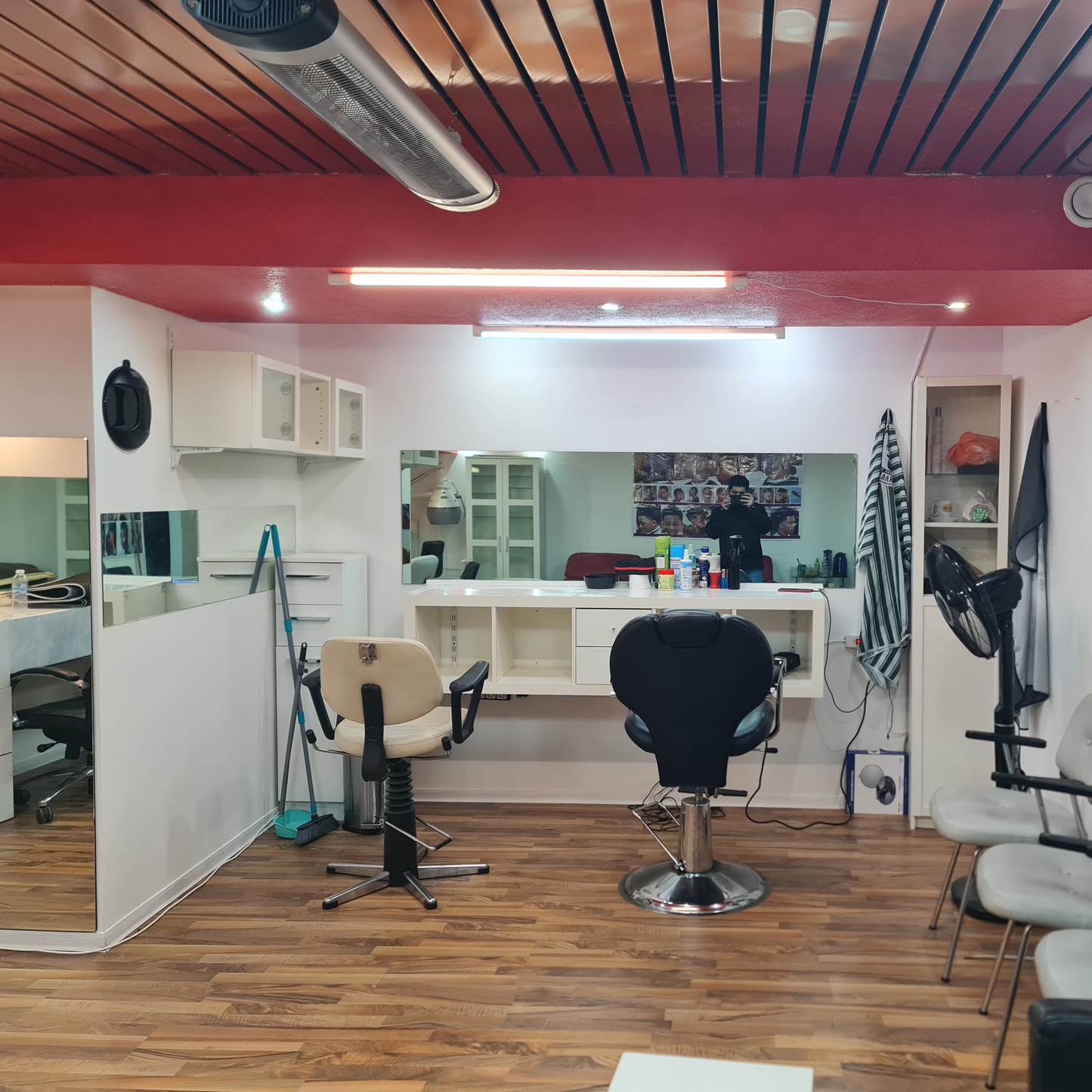 Salon interior with chairs, mirrors, and wall decorations.